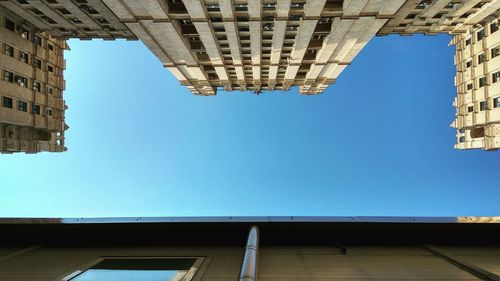 Low angle view of buildings against blue sky