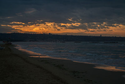 Scenic view of beach against sky during sunset