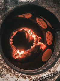 High angle view of lit candles on cake