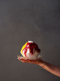 Close-up of hand holding ice cream