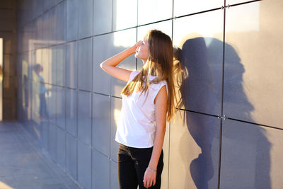 Rear view of young woman standing in city