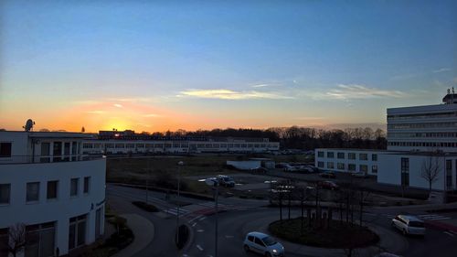 Vehicles on road at sunset