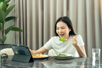 Woman sitting on table