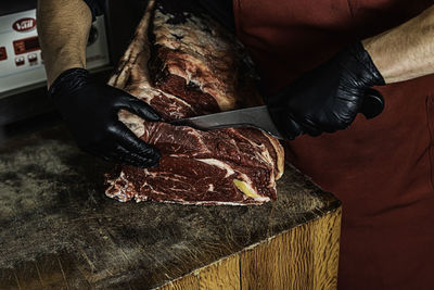 Butcher preparing and cutting meat. close-up view