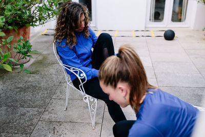 Mother and daughter sitting outdoors