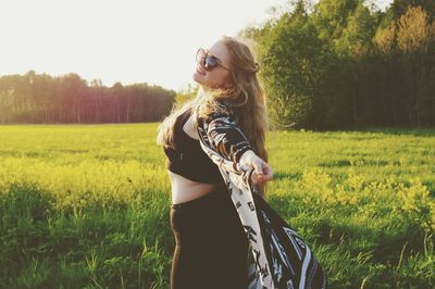 Young woman standing on field