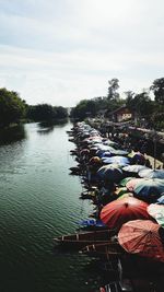 People by river against sky