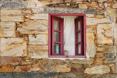 Close-up of window on brick wall of building