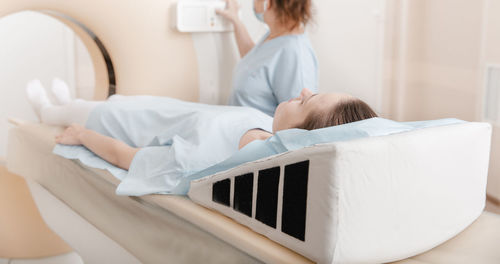 Patient lying on bed in ct scan room