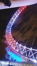 Low angle view of illuminated ferris wheel against sky at night