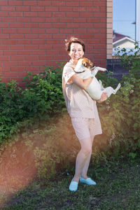 Full length of young woman standing on field