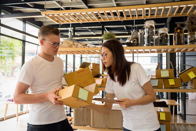 Man giving boxes to woman