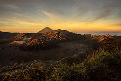 Panoramic view of volcanic landscape against sky during sunset