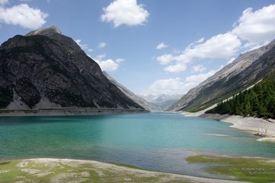 Scenic view of lake and mountains against sky