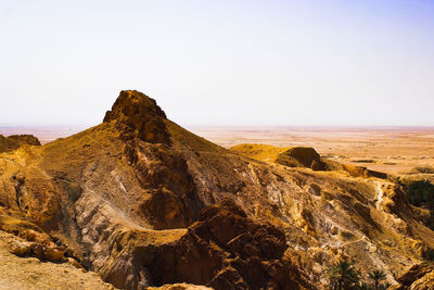 Rock formations on landscape against clear sky in desert 