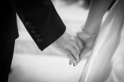 Close-up of couple holding hands