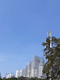 Low angle view of modern buildings against clear blue sky