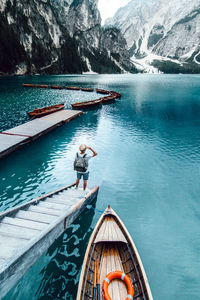 Man in boat on lake against mountain
