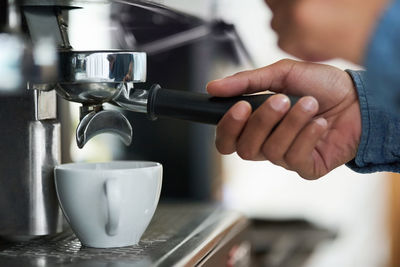 Midsection of man holding coffee