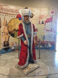 Portrait of young man standing against wall