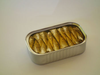 High angle view of bread in plate against white background