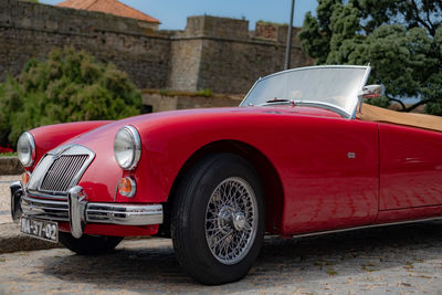 Red vintage car in city