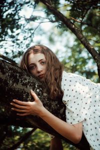 Portrait of young woman in forest