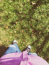 Low section of person standing on grass