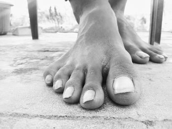 Low section of woman wearing shoes