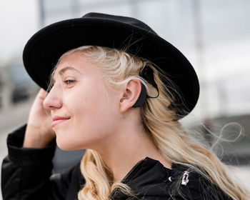 Close-up of young woman wearing hat