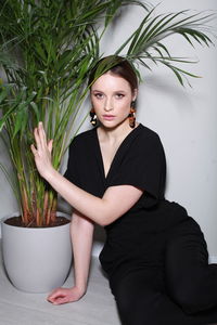 Portrait of young woman standing against sky