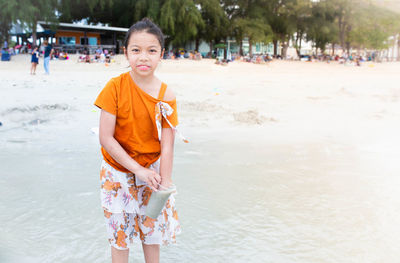 Portrait of boy standing on beach