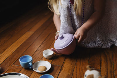 Midsection of girl playing with toys at home