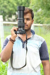 Portrait of young man photographing