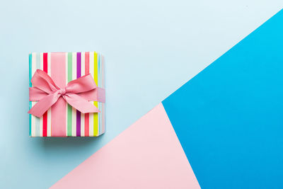 High angle view of gift box against blue background