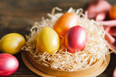 Multicolored easter eggs on a wooden background.