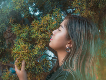 Portrait of girl looking at tree