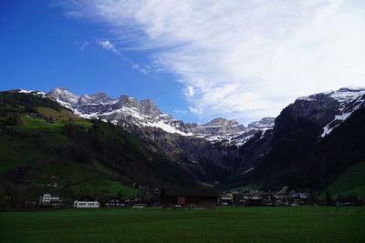 Scenic view of landscape and mountains against sky