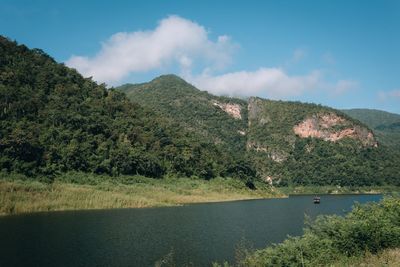 Scenic view of lake and mountains against sky