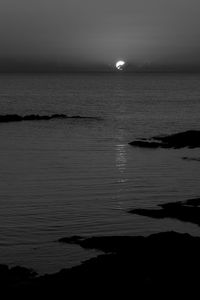 Scenic view of sea against sky at night