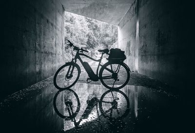 Shadow of man on bicycle against wall