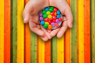 Directly above shot of boy holding multi colored balls