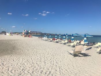 Scenic view of beach against blue sky