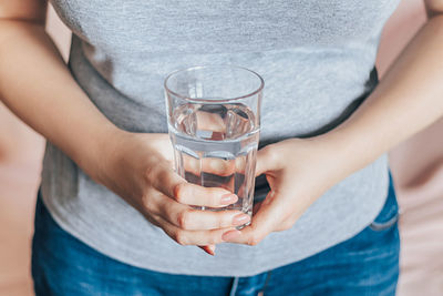 Midsection of woman holding drink