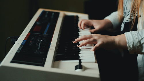 Close-up of person playing piano