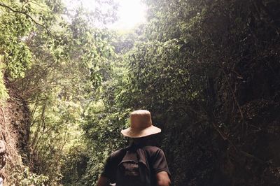 Midsection of woman against trees in forest