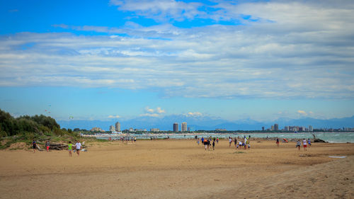 People on beach against sky