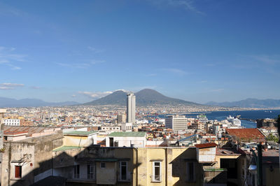 Buildings in city against blue sky