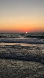 Scenic view of sea against clear sky during sunset