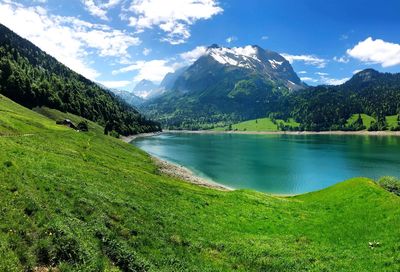 Scenic view of lake and mountains against sky